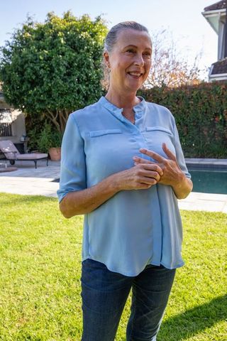 Senior Woman Enjoying Relaxed Moment at Backyard