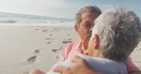 Romantic Senior Couple Embracing on Beach