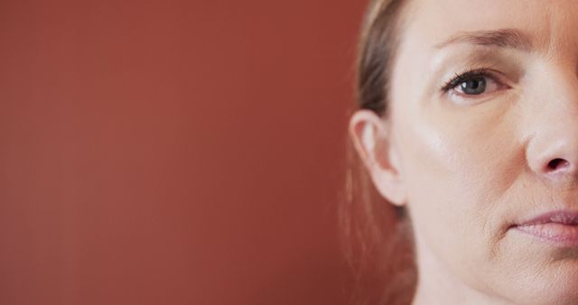 Close-Up Portrait of Thoughtful Woman Against Red Wall - Download Free Stock Images Pikwizard.com