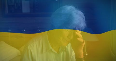 Senior woman crying under ukraine flag