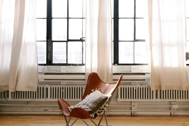 Minimalist Loft Interior with Leather Chair and Soft Lighting - Download Free Stock Photos Pikwizard.com