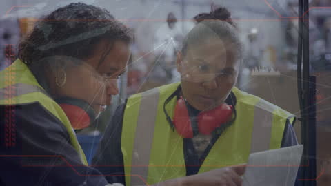 Diverse Female Workers Collaborating in High-Tech Warehouse