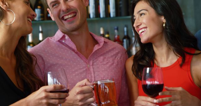 People socializing at a bar while enjoying wine and beer, perfect for promoting bar events, social gatherings, nightlife, or leisure activities.