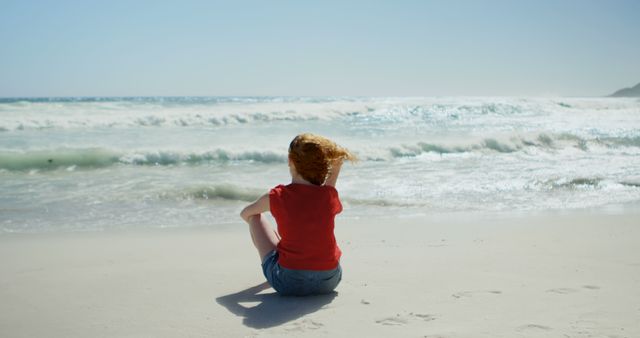 Woman Sitting on Sandy Beach with Waves Crashing in Distance - Download Free Stock Images Pikwizard.com