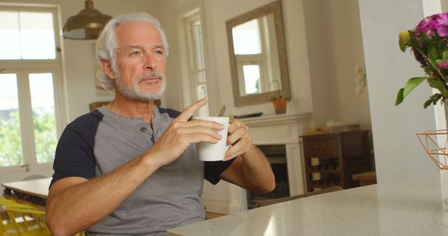 Senior Man Sipping Coffee in Modern Kitchen - Download Free Stock Images Pikwizard.com