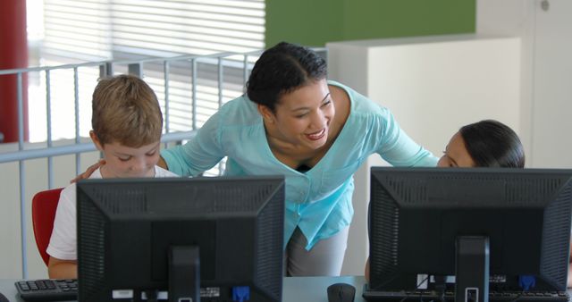 Teacher guiding students using computers in classroom - Download Free Stock Photos Pikwizard.com