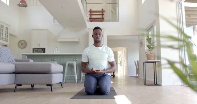 Meditating African American Man in Modern Home Interior - Download Free Stock Images Pikwizard.com