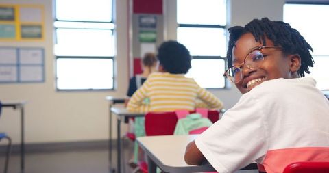 Diverse Students Engaging in Classroom Learning with Red Chairs