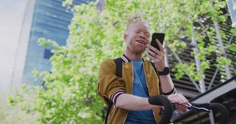 Urban Cyclist Engages with Smartphone in City Setting