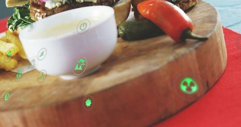 Rustic wooden serving board with sandwich, dipping bowl and chili peppers plus ar icons