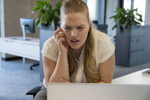Businesswoman Engaged in Serious Work Call in Open Plan Office