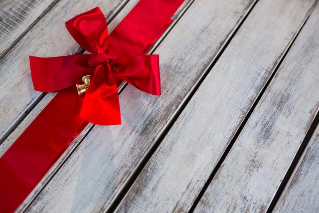 Red ribbon tied on wooden plank during christmas tree