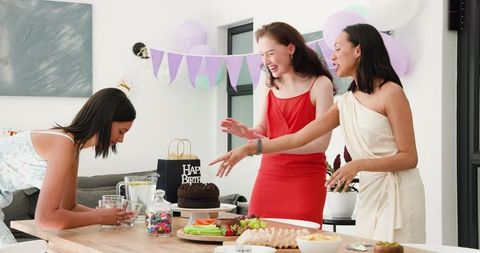 Friends Preparing Table for Birthday Celebration at Home