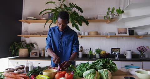 Man Cooking with Fresh Vegetables in Modern Kitchen