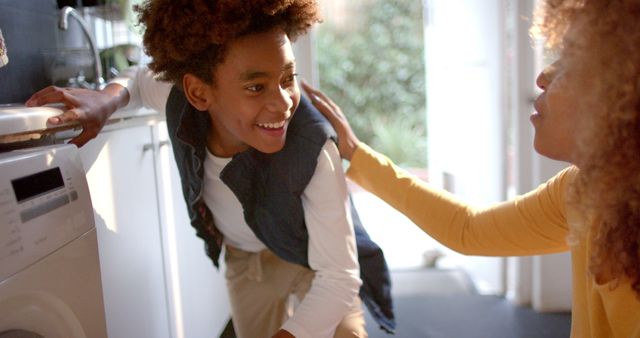 Mother and son smiling and bonding in kitchen setting - Download Free Stock Images Pikwizard.com