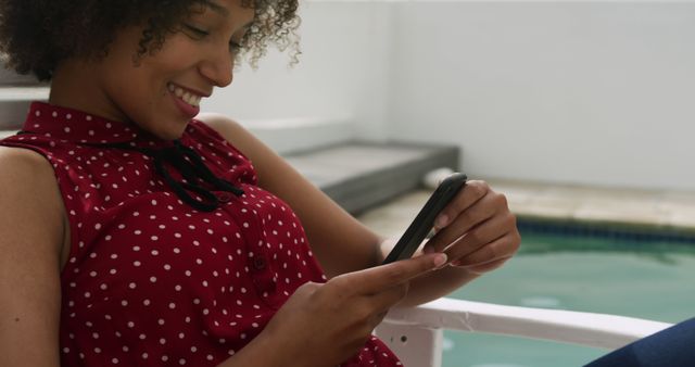 Smiling Woman Relaxing by Pool with Mobile Phone - Download Free Stock Images Pikwizard.com