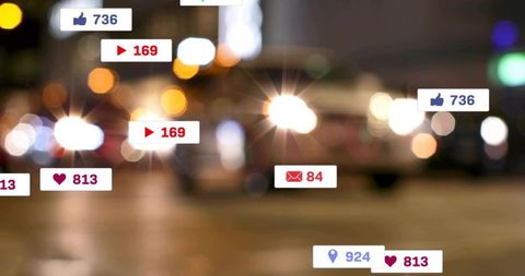 Social media notification badges floating over blurred night street bokeh and headlights