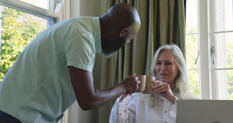 Diverse Team Collaborating at Home with Laptop