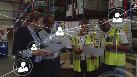 Warehouse Team Reviewing Logistics Devices with Network Overlay Visualizing Supply Chain