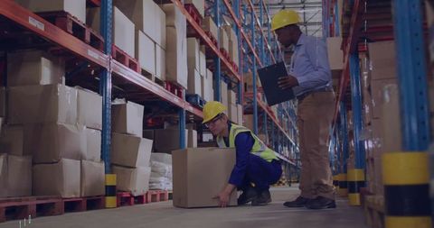 Warehouse workers practicing effective box-lifting techniques for safety