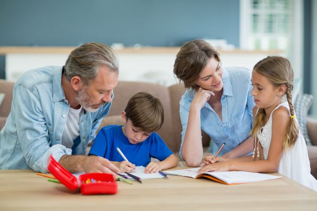Siblings getting help with homework from parents in living room at home