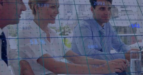 Business Team Analyzing Data with Digital Grid Overlay in Modern Office Meeting