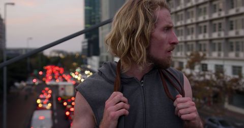 Focused Athlete Standing on Urban Bridge