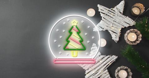 Bright neon christmas tree snow globe with festive decor