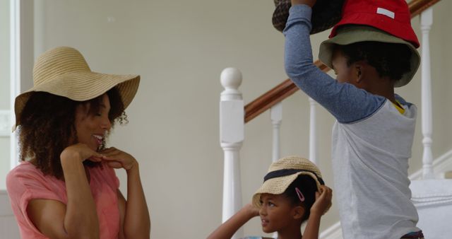 Happy African American Family Wearing Hats and Playing at Home - Download Free Stock Images Pikwizard.com