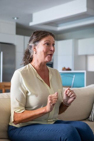 Excited Senior Woman Socializing in Contemporary Living Space