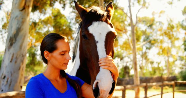 A young Caucasian woman gently interacts with a horse, showcasing a bond between human and animal - Download Free Stock Photos Pikwizard.com