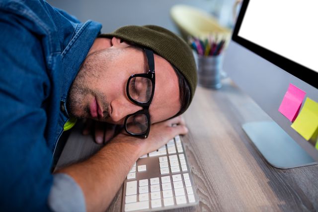 Hipster businessman sleeping at his desk - Download Free Stock Photos Pikwizard.com