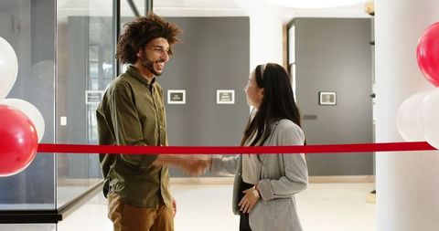 Happy Colleagues Shaking Hands at Office Opening Ceremony