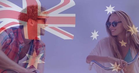 Couple riding bikes and smiling with australian flag overlay celebrating summer travel
