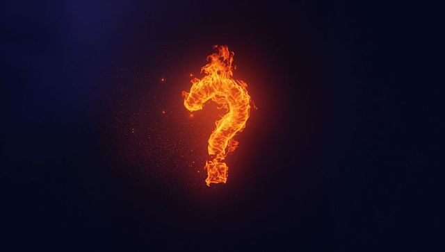 Flaming Question Mark Illuminating Dark Backdrop