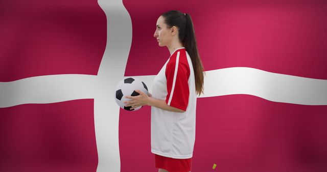 Caucasian Female Soccer Player Holding Ball Against Denmark Flag - Download Free Stock Images Pikwizard.com