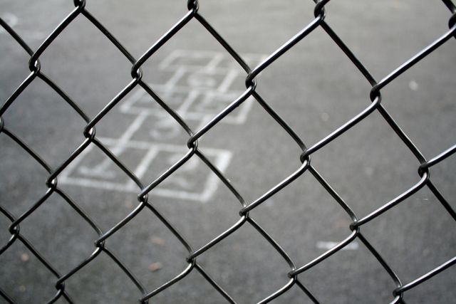 Hopscotch Game through Chain-Link Fence on Blacktop - Download Free Stock Photos Pikwizard.com