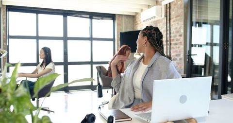 Multiracial Female Team Collaborating in Modern Office