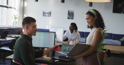 Two colleagues analyzing data in modern co-working space