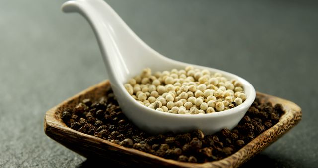 Contrasting Peppercorns in Ceramic Spoon and Wooden Dish - Download Free Stock Images Pikwizard.com