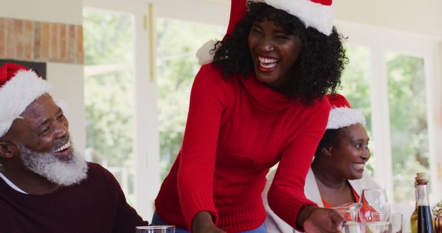 Family Celebrating Christmas Wearing Santa Hats and Smiling - Download Free Stock Images Pikwizard.com