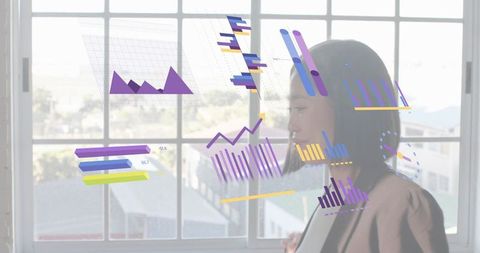 Japanese businesswoman examining data visualization overlay on window with urban rooftops