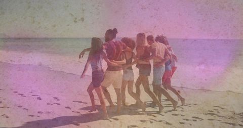 Seven friends walking arm in arm on sunlit beach with retro film grain and pastel tones