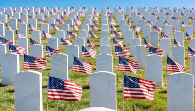 Endless rows of marble headstones lined with american flags memorial day tribute