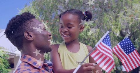 Father and Daughter Celebrating USA Outdoors with Flags