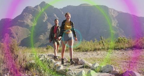 Couple Hiking Scenic Mountain Trail with Colorful Lens Flare