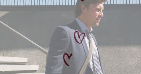 Businessman climbing stairs with heart graphics symbolizing passion and success