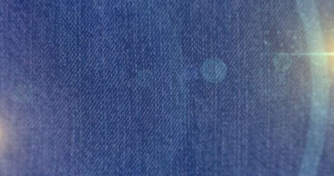 Abstract light spots over denim fabric
