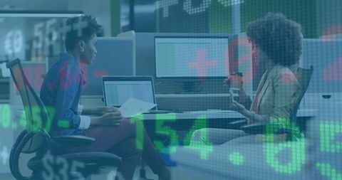 Businesswomen analyzing documents in modern office environment