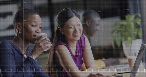 Diverse Colleagues Discussing Financial Data on Laptop